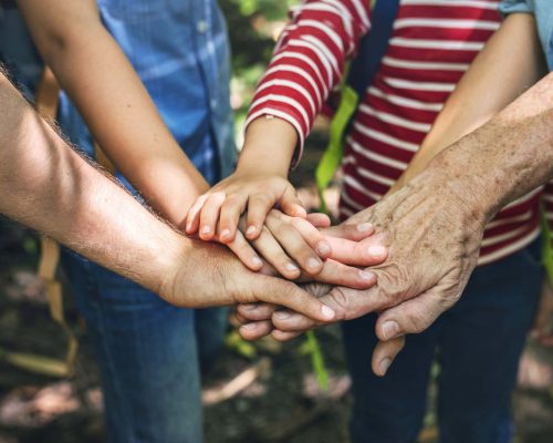 Family stacking hands as a team Family stacking hands as a team